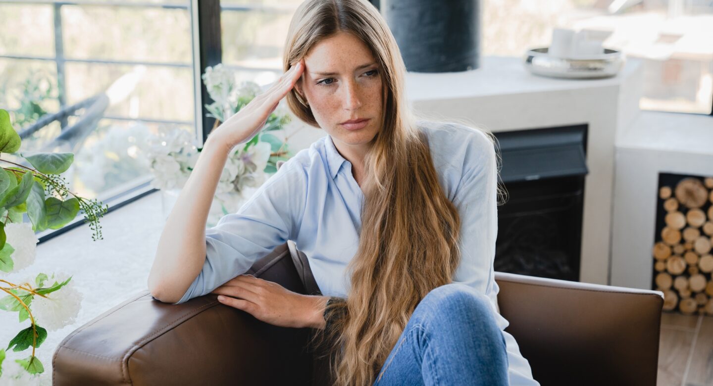 Pensive,Young,Woman,Sitting,In,The,Armchair,Thinking,About,Sad
